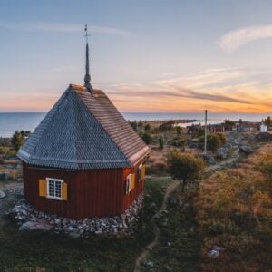 Scenic sunset by a wooden coastal cabin