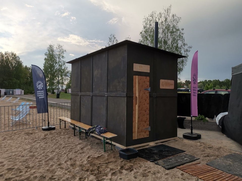 Beachside sauna with flags and benches