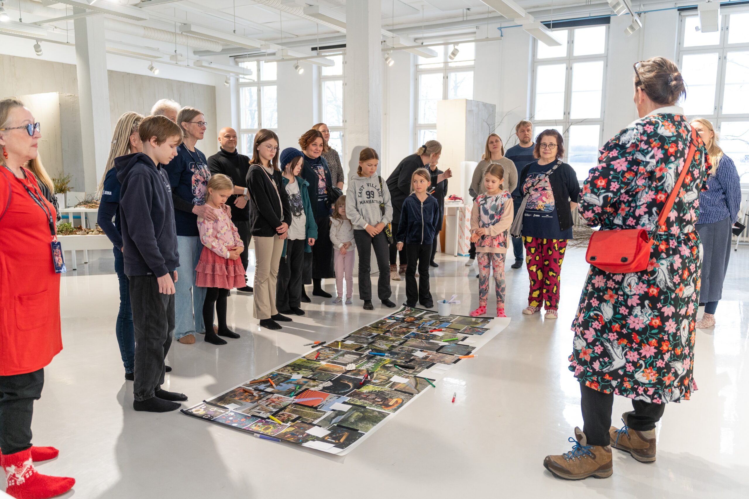 kuvassa paljon lapsia ja aikuisia seisomassa taidenäyttelyssä