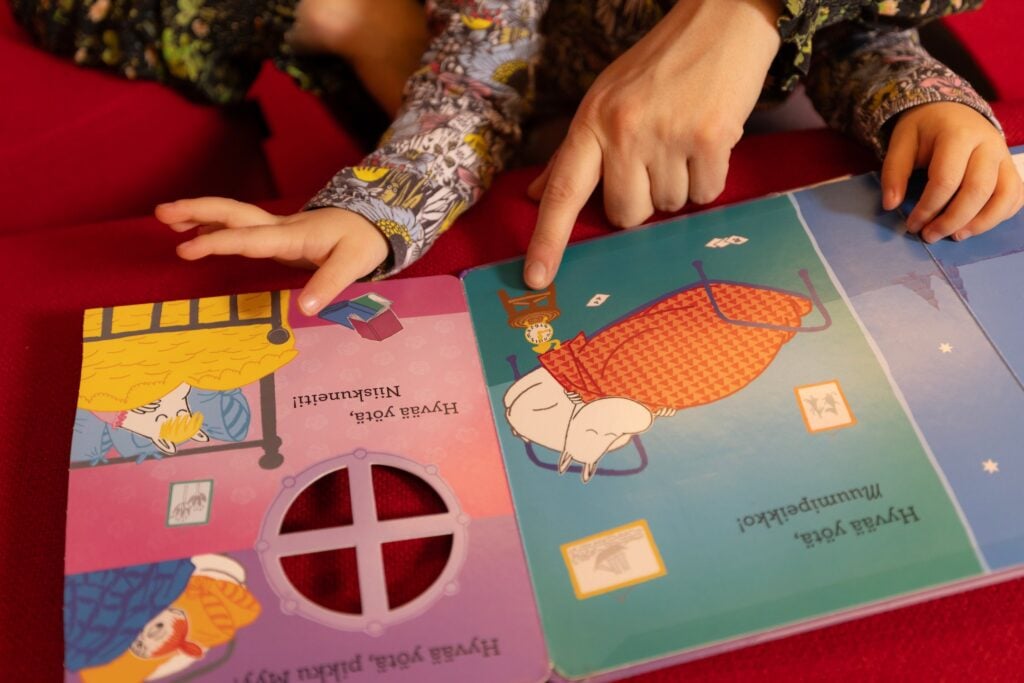 book and a childs hand