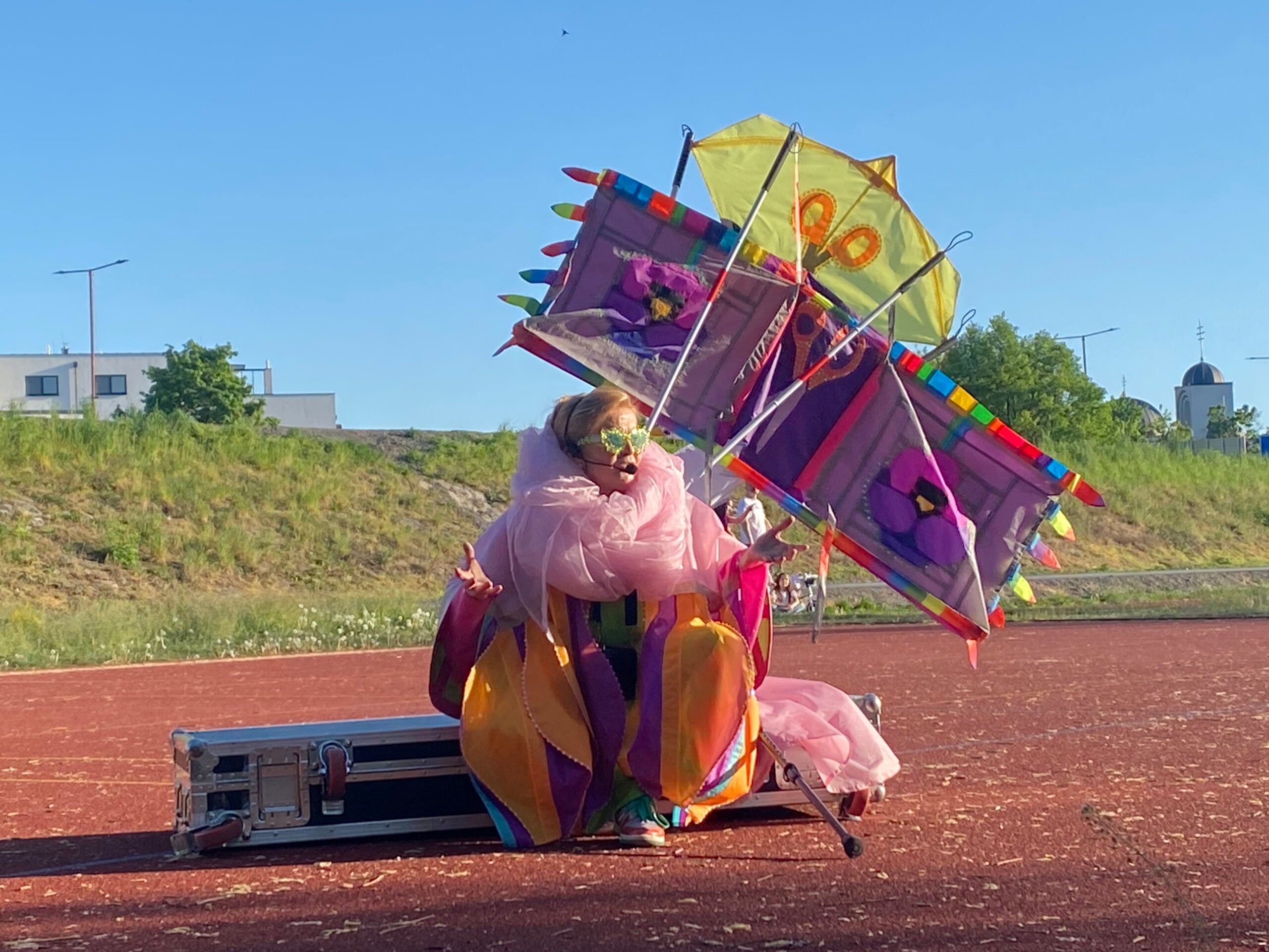 The artist Jenni-Juulia Wallinheimo-Heimonen giving a speech on the side of the sports field in Trenčin. Photo: Taina Kulmala.